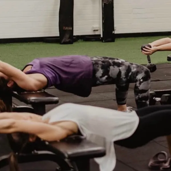 Members doing push-ups on the turf
