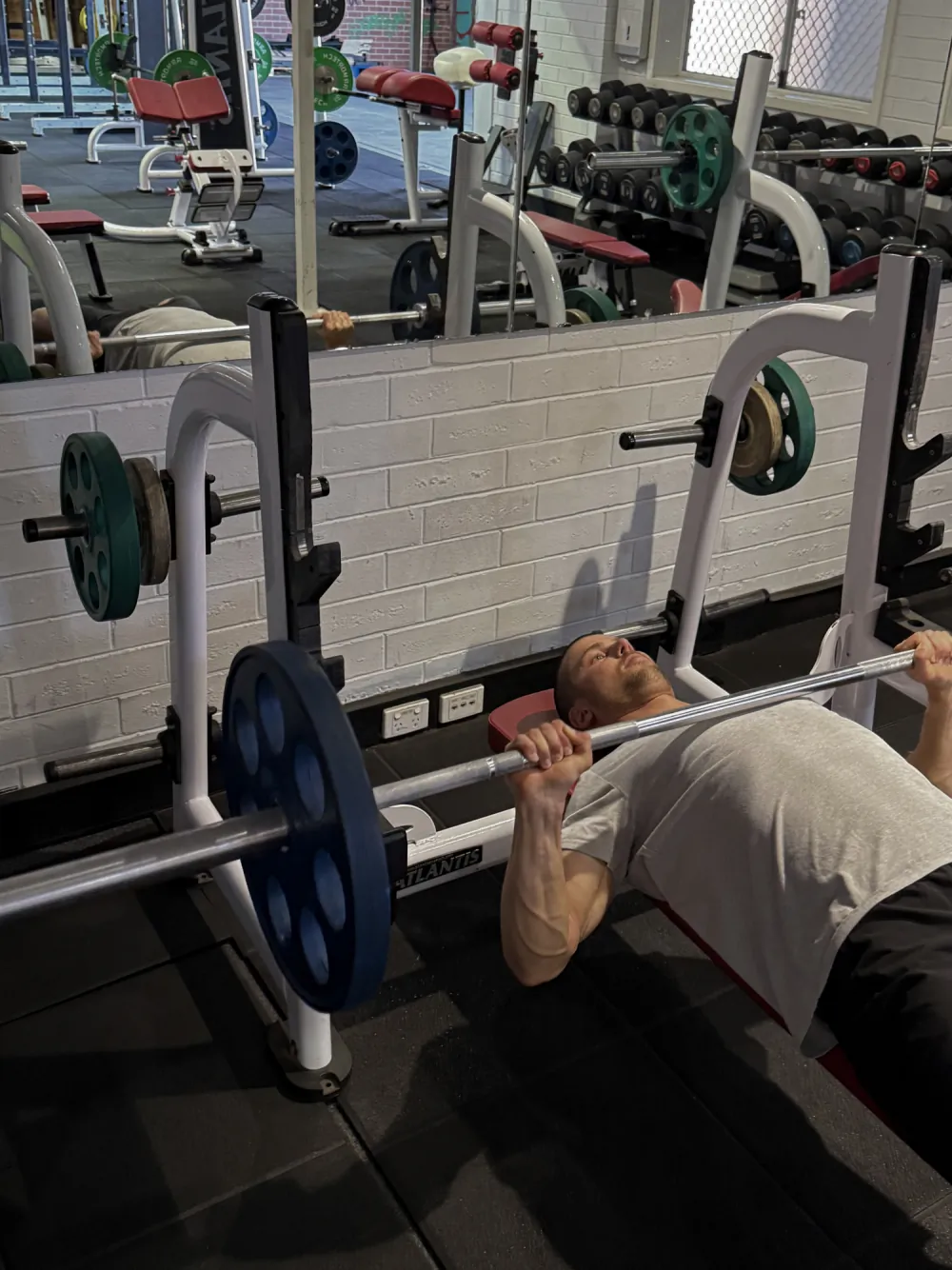 A member bench pressing at Tribe Wellness Co