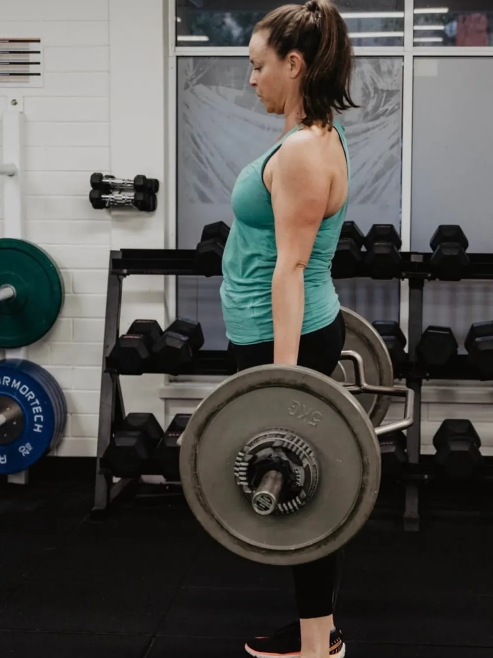 Dumbbell rack on the gym floor at Tribe Wellness Co