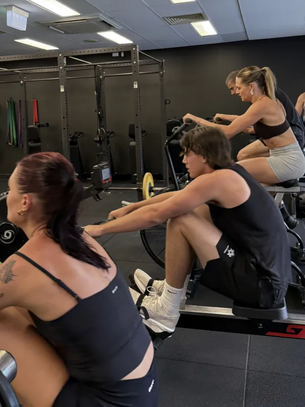 Four people on rowing machines