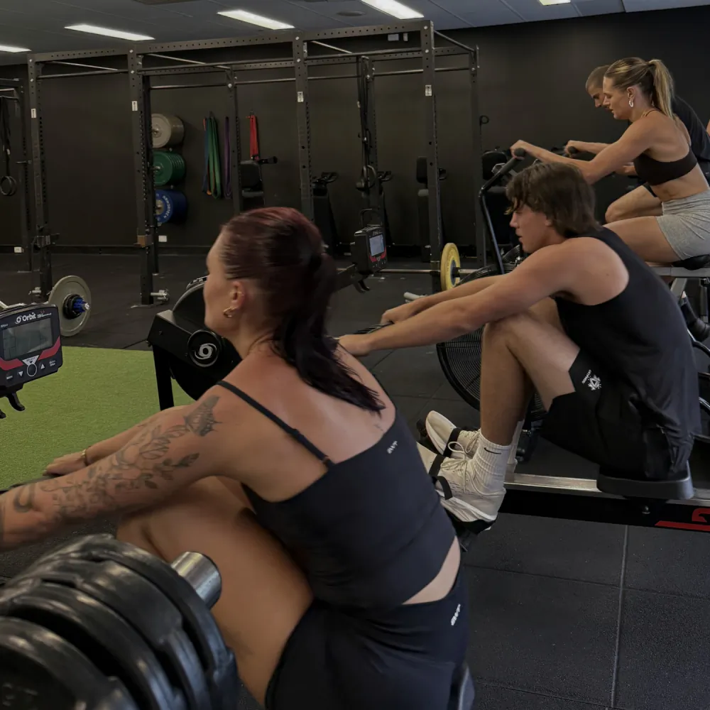 Members rowing together in a small group class